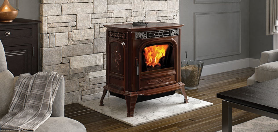 Harman XXV-TC pellet stove in a warm living room with a stone surround