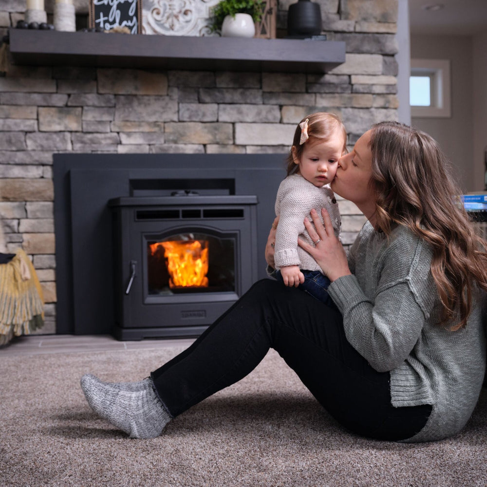 Harman P42i-TC pellet insert in a family room; finish and installation materials may be optional