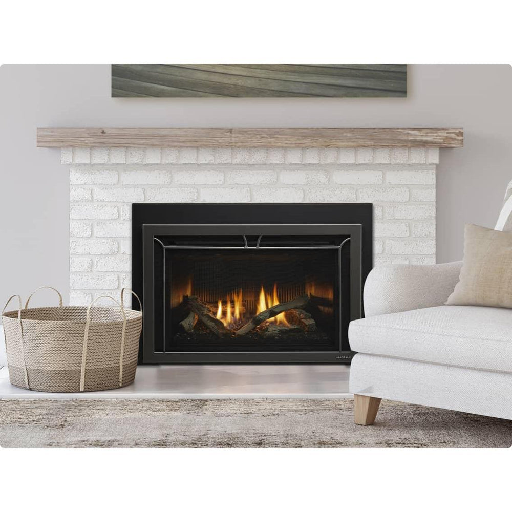 Heat & Glo Cosmo 35Ó gas fireplace insert with driftwood logs, fluted black glass and Iron Age front in living room.. Official series image; size, front and optional finishes may differ from the quoted configuration.