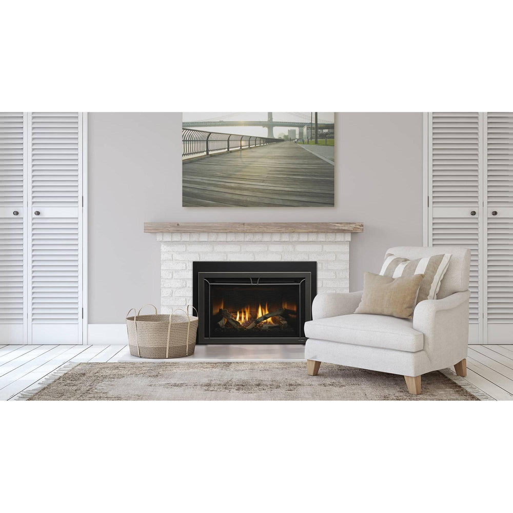 Heat & Glo Cosmo 35" gas fireplace insert with driftwood logs, fluted black glass and Iron Age front in living room.. Official series image; size, front and optional finishes may differ from the quoted configuration.