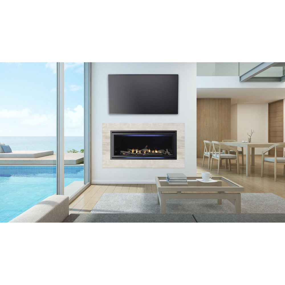 Heat & Glo Cosmo 42" linear indoor gas fireplace with driftwood logs and Thala Beige surround in modern room near pool. — official Cosmo Linear Gas Fireplace series image; may show a different size and separately selected options