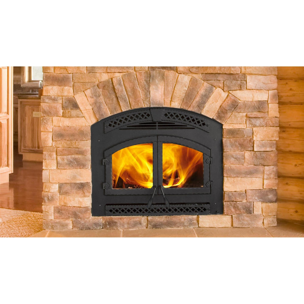 Heat & Glo Northstar wood-burning fireplace in log cabin living room with brick hearth wall with doors closed and fire.. Official series illustration; size and optional finishing may differ from this model.