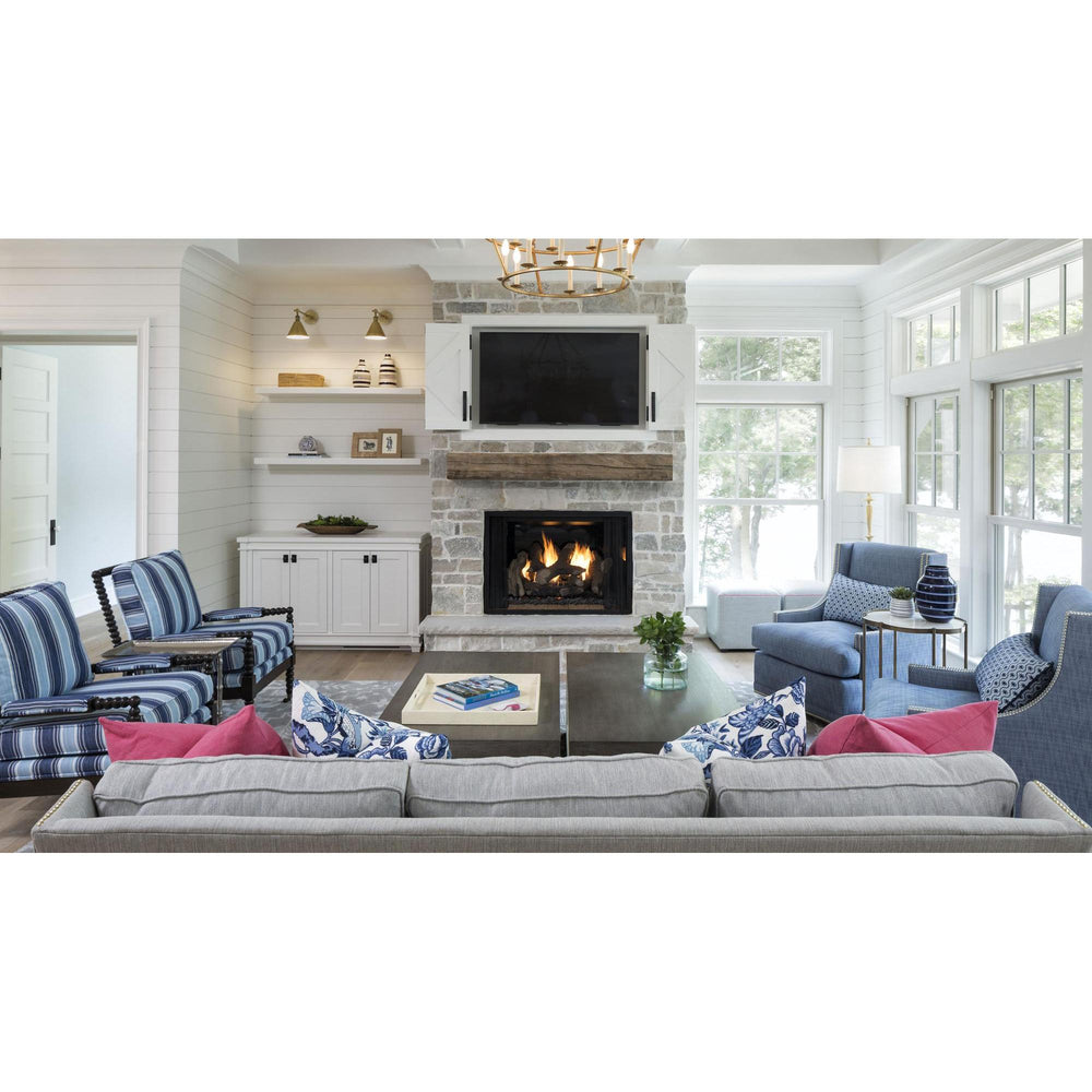 Alt: Heat & Glo Phoenix TrueView indoor gas fireplace in white stone hearth with wood mantel and TV overhead in living room. — official Phoenix TrueView Indoor Open Gas Fireplace series image; may show a different size and separately selected options