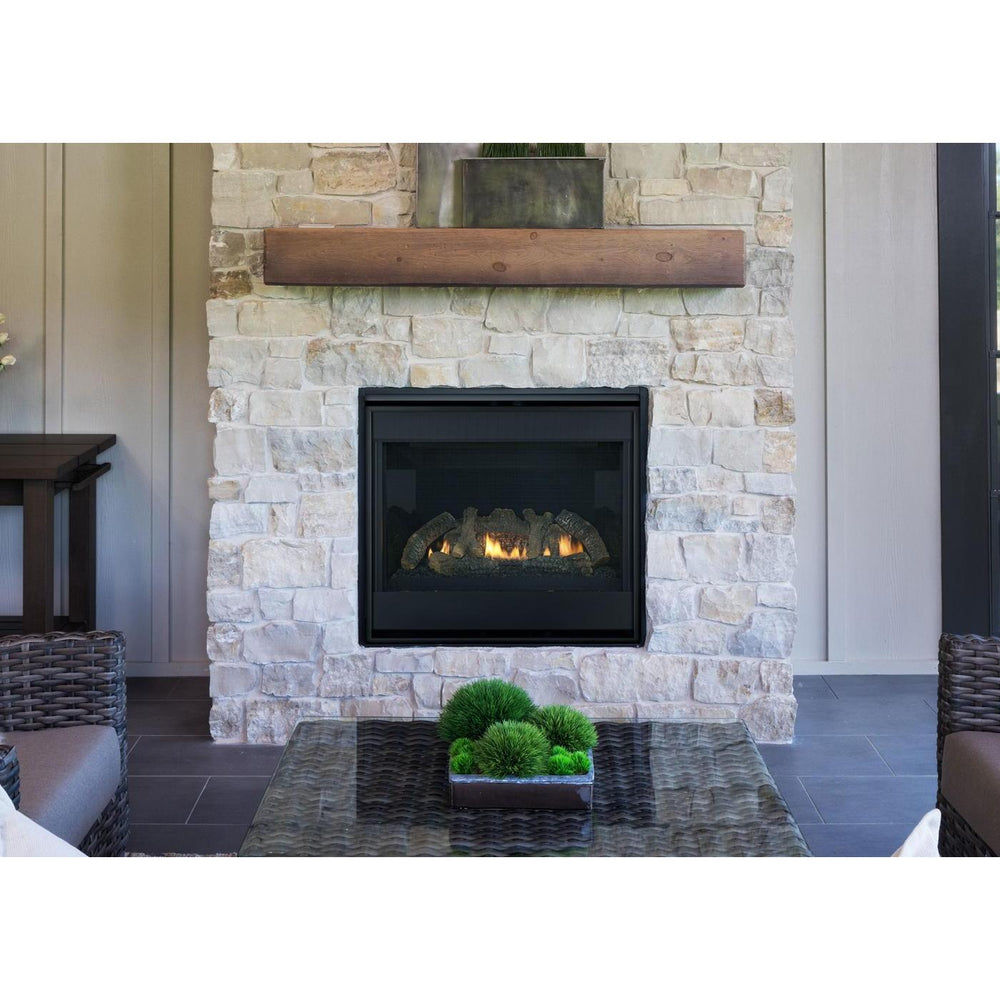 Heat & Glo SlimLine SL Fusion indoor gas fireplace with natural logs and black interior on white stone wall in living room. — official SlimLine Fusion Series Indoor Gas Fireplace series image; may show a different size and separately selected options