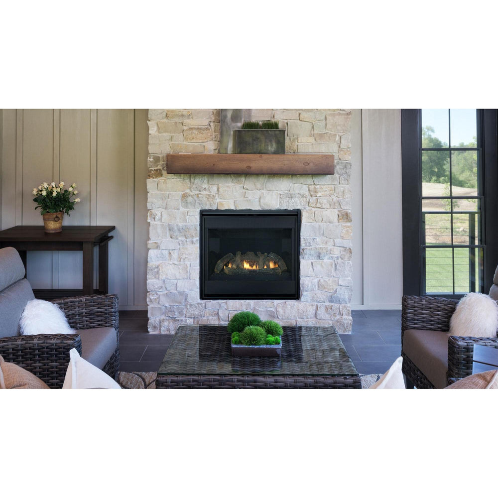 Heat & Glo SlimLine SL Fusion indoor gas fireplace with natural logs and black interior on white stone wall in living room. — official SlimLine Fusion Series Indoor Gas Fireplace series image; may show a different size and separately selected options