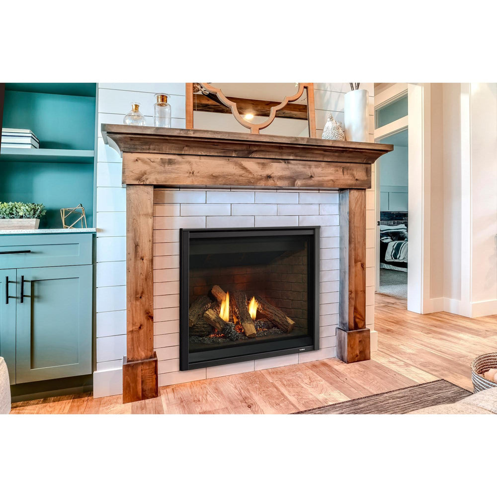 Traditional gas fireplace with three-sided wood mantel surround is inset into white wall with subway tile. — official Caliber Gas Fireplace series image; may show a different size and separately selected options