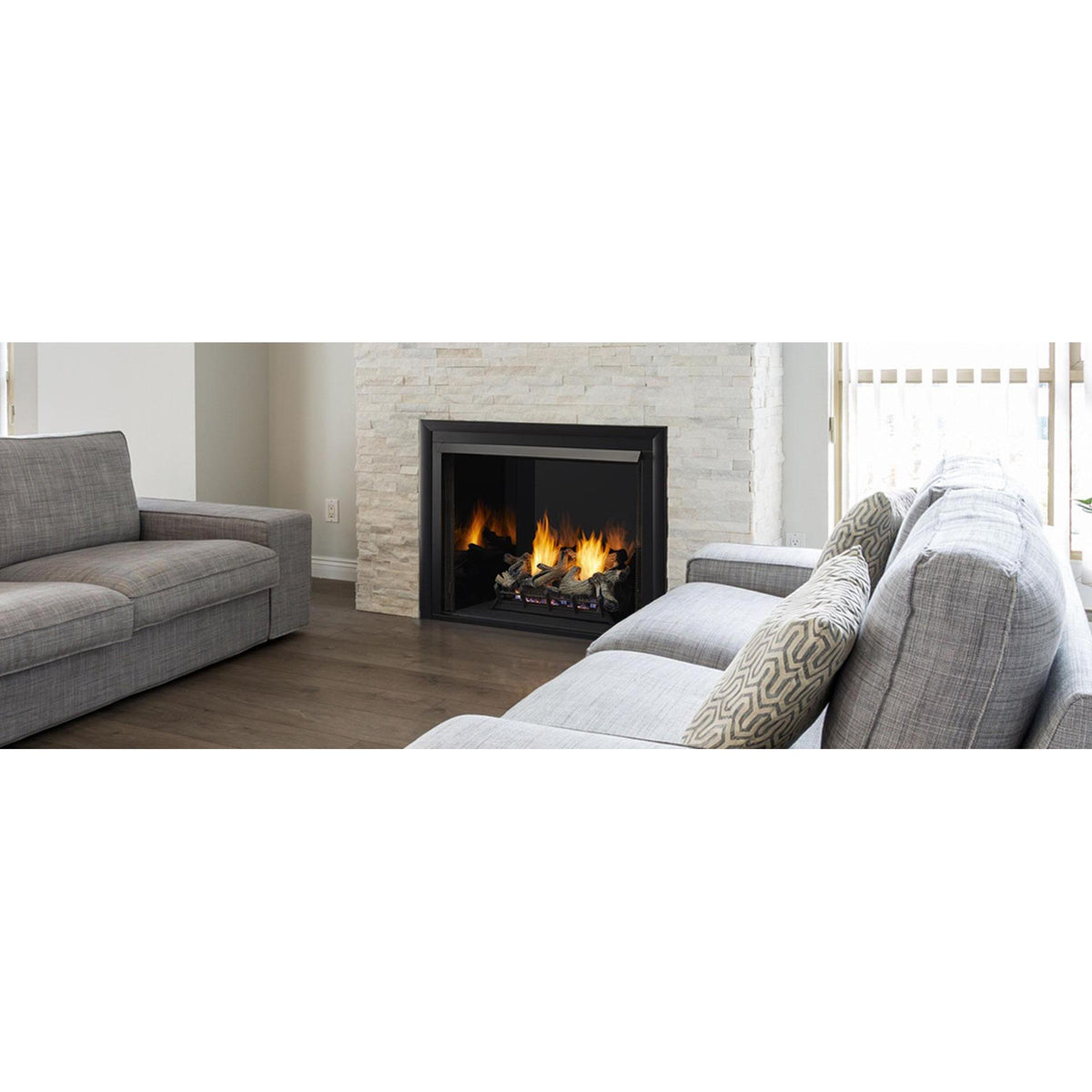 Lo-Rider 36 series illustration: Modern living room with natural light and floor-to-ceiling stone fireplace and reflective black glass interior panels. ; exact pictured size may differ, and gas logs, burner, accessories and finishes are separate.