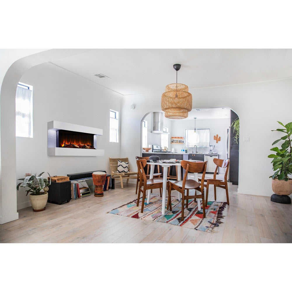 GettyImages_1093636860 Modern electric fireplace with logs, orange flame and floating mantel in mid-century modern space with table and chairs. Different required mantel configurations and separately supplied room materials are shown.