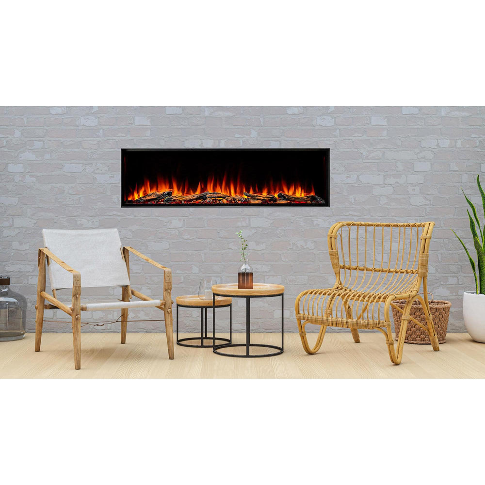 SimpliFire Forum 55: Outdoor electric fireplace with driftwood logs in stacked-stone hearth wall sets off poolside lounge with bamboo chairs. Optional logs and surrounding finishes may be shown.